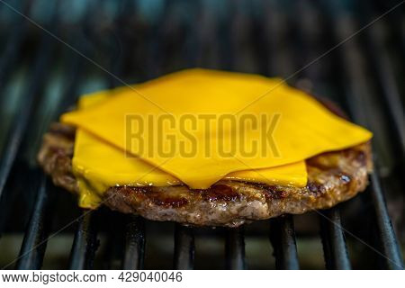 Meat And Cheese Are Grilled On A Barbecue Grid. Raw Cutlet Being Fried On Grill. Unhealthy Tasty Dis