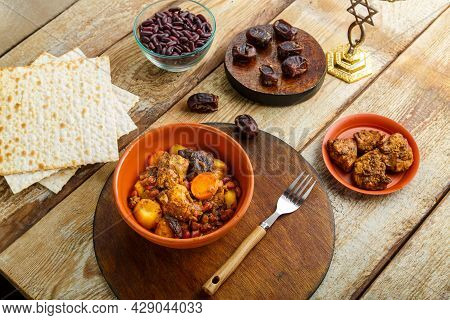 Jewish Dish Shuttle With Meat In A Dish On A Wooden Table Near Matzo And Ingredients. Horizontal Pho