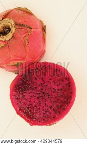 Vertical Image Of Dark Pink Dragon Fruit Or Pityaya Against White Background