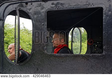 Neuf-brisach, France, June 27, 2021 : Two Volunteers Operates Old Steam Or Electric Locomotives.