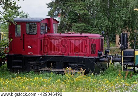 Neuf-brisach, France, June 27, 2021 : Old Red Locomotive In The Fields