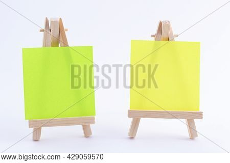 Two Wooden Easels Miniature With Blank Colored Square Canvas Or Memo Paper - Mockup. Mini Wooden Sta
