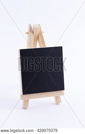 Wooden Easel Miniature With Blank Black Square Canvas For Artists And Painters - Mockup. Mini Wooden