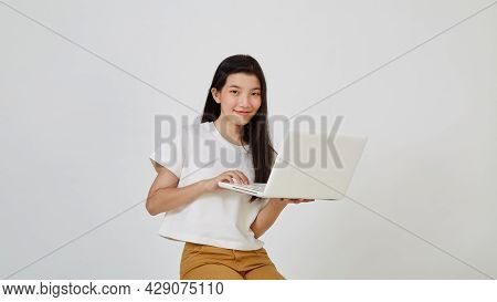 Woman With Laptop Computer Sitting Cross Legged And Looking