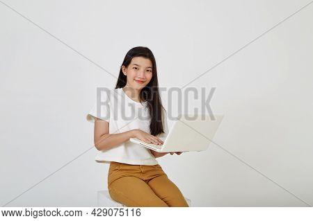Woman With Laptop Computer Sitting Cross Legged And Looking
