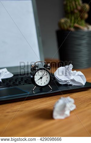 Workplace, Wooden Office Desk With Clock, Sheet Of Paper, Laptop, Notebook, Crumpled Paper