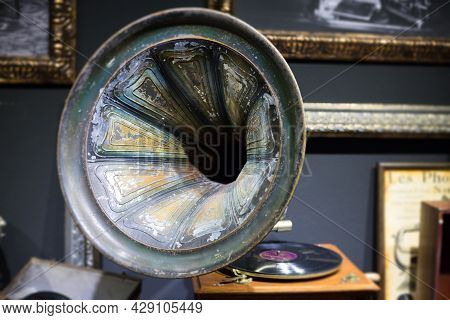 An Old Gramophone With A Record Or Vinyl Disc On A Wooden Box. Antique Brass Record Player. Gramopho