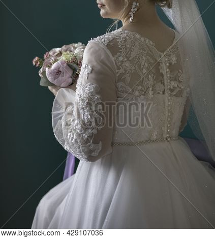 Woman With Bridal Bouquet. Eremony Wedding Day. Hands With Wedding Rings.