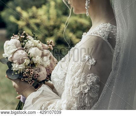 Woman With Bridal Bouquet. Eremony Wedding Day. Hands With Wedding Rings.