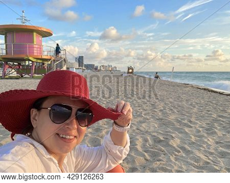 Young Woman Waering Red Hat Taking A Selfie At South Beach, Miami, Usa
