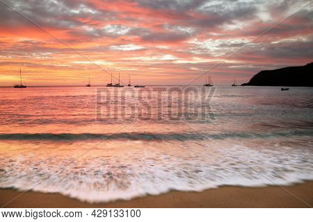 A Sunset Over A Body Of Water