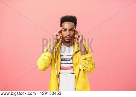 Using Power Of Mind Or Thelepaty. Portrait Of Focused Handsome Dark-skinned Male With Afro Hairstyle