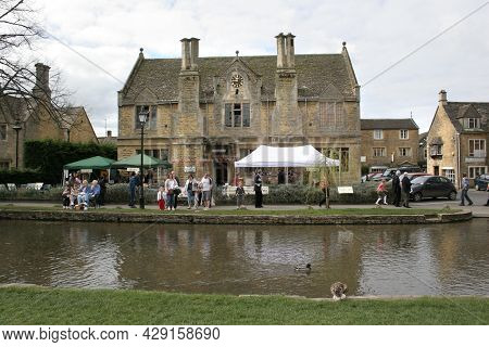 People By The River Windrush In Bourton On The Water In Gloucestershire In The Uk, Taken 10th April 