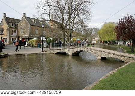 People By The River Windrush In Bourton On The Water In Gloucestershire In The Uk, Taken 10th April 