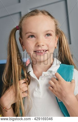 Happy Schoolchild In The Classroom With Big Backpack And Positive Emotions. Excieted And Ready To St