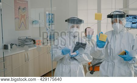 Dentistry Team Of Specialists Using Sticky Notes On Glass In Stomatology Cabinet To Explain Teethcar