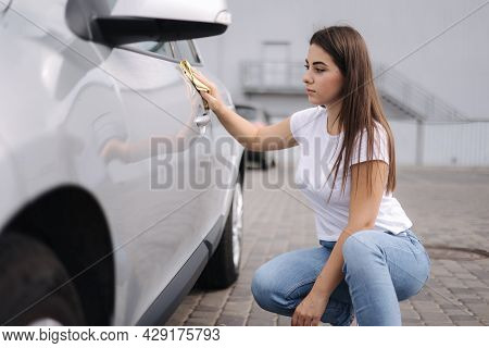 Attractive Happy Joyful Female Driver Wipe Her Car Using Rag In Self-service Car Wash