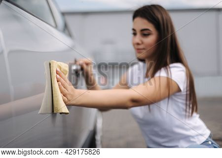 Attractive Happy Joyful Female Driver Wipe Her Car Using Rag In Self-service Car Wash