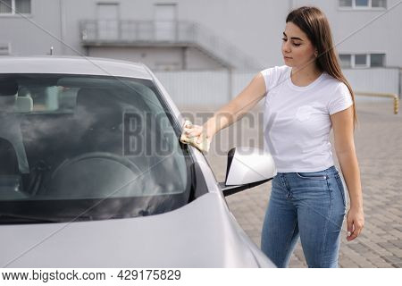 Attractive Happy Joyful Female Driver Wipe Her Car Using Rag In Self-service Car Wash