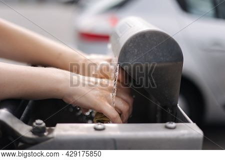 Female Wash Rug In Water. Close-up Womans Hand In Front Of Car On Sel Servise Car Wash
