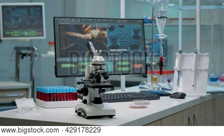 Microscope On Laboratory Desk With Medical Research Equipment At Hospital Clinic. Modern Technology 