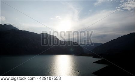Aerial View Of A Calm Lake Water Surface With The Sun Reflection. Action. Breathtaking Summer Scener