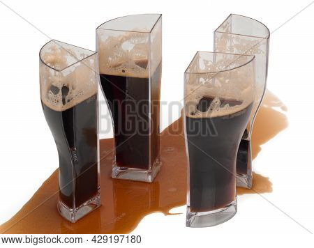 Dark Beer In Four Glasses That Can Be Combined Into One Glass. Glass, Divided Into Four Parts