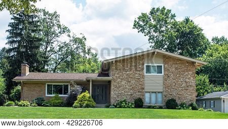 Tan Flagstone House with Various Shrub Landscaping