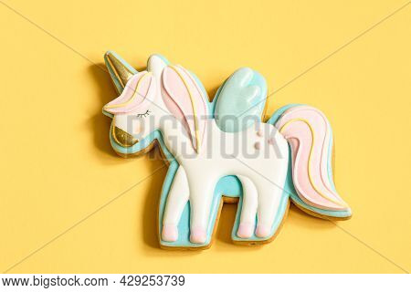 Close-up Of Colorful Gingerbread In The Shape Of A Unicorn On A Yellow Background.