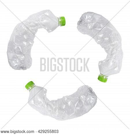 Three Crashed Plastic Bottles On White Isolated Background Form Resycling Sign. Plastic Utilisation 