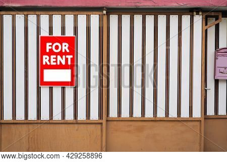 Red For Rent Real Estate Sign In Front Of Beautiful House. House For Rent Concept