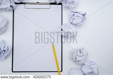 Total White Monochromatic Stationery Flat Lay. Notepad, White Pencil And Crumpled Paper Balls On Whi