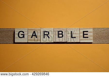 Gray Word Garble Made Of Wooden Square Letters On Brown Background