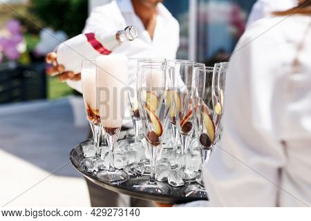 Midsection Of Waiter Pouring Champagne At Poolside.serving With Ice On A Tray. Swimming Pool Party C