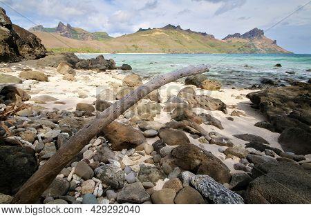 A Rocky Beach Next To A Body Of Water