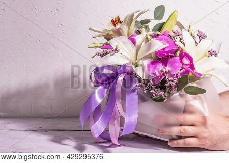 Man's Hands Are Holding Bouquet. A Beautiful Bouquet Of Fresh Flowers On A White Background