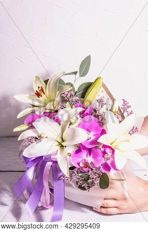 Man's Hands Are Holding Bouquet. A Beautiful Bouquet Of Fresh Flowers On A White Background