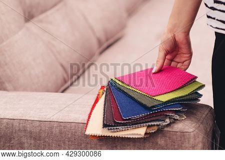 Woman Chooses The Colors And Patterns Of Upholstery Fabrics. Textile Industry Background. Tissue Cat