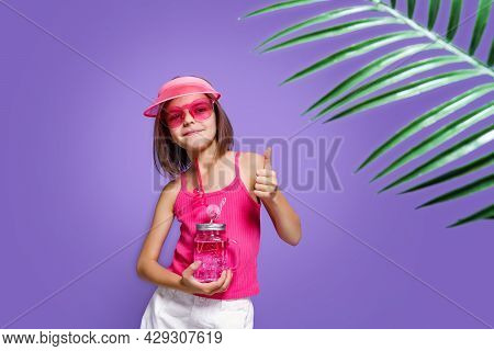 A Little Girl In White Shorts, A Pink T-shirt, Pink Trendy Glasses, With A Drink In Hand And A Summe