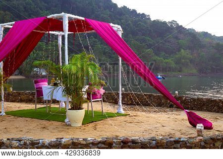 An Impromptu Gazebo With A Table On The Seashore. Dinner On A Tropical Island. Travel And Tourism.