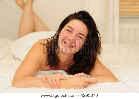 Young Woman Laying On Bed