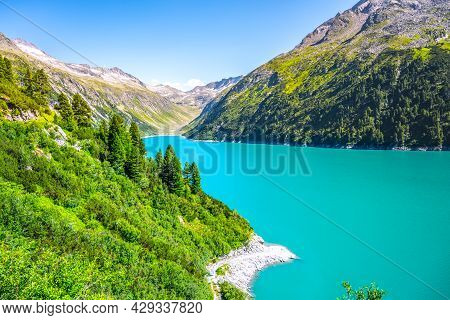 Vivid Blue Mountain Lake In Summer Alps. Speicher Zillergrundl Dam, Zillertal Alps, Austria