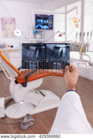 Radiologist Looking At Dental Teeth Jaw Medical Radiography Working At Teethcare Treatment In Stomat