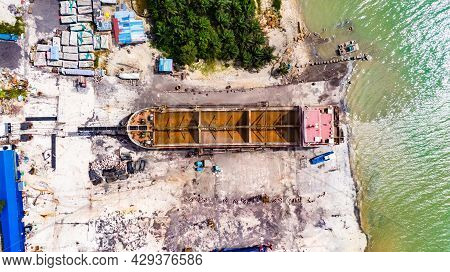 Old Fisher Boat In The Shipyard At Johor Bahru,  Malaysia. A Wooden Boat Outside Of The Sea For Repa
