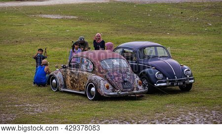 Putrajaya, Malaysia - October 11, 2020: Two Malay Families Meet With Their Old Volkswagen Beetle In 