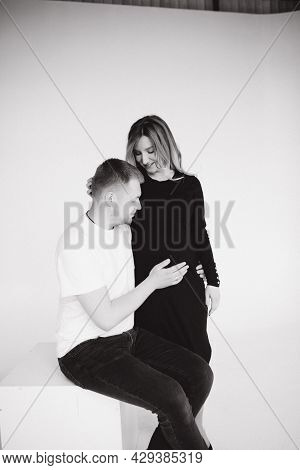 Happy Future Parents Of Man And Pregnant Woman Puts Hands On Belly And Waiting For Beby Movement In 