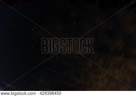 A Dark, Moonless Night. You Can See Shining Stars In The Black Sky, You Can See A Fragment Of The Mi