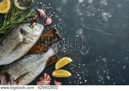 Raw Dorado Fresh Fish Or Sea Bream With Ingredients For Making Lemon, Thyme, Garlic, Cherry Tomato A