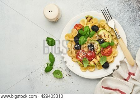 Pasta Fiocchi Salad With Vegetables Grilled Zucchini, Cherry Tomato, Olives, Basil And Parmesan Chee