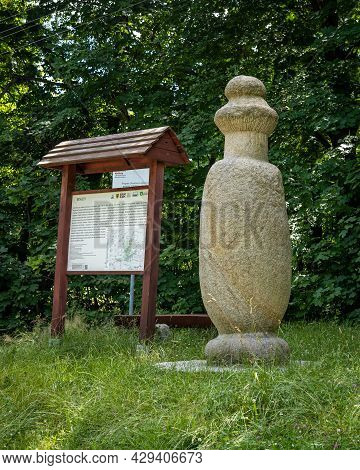 Sobotka, Poland - July 6, 2021: A Prehistoric Stone Monk Statue And Information Board On A Tourist R